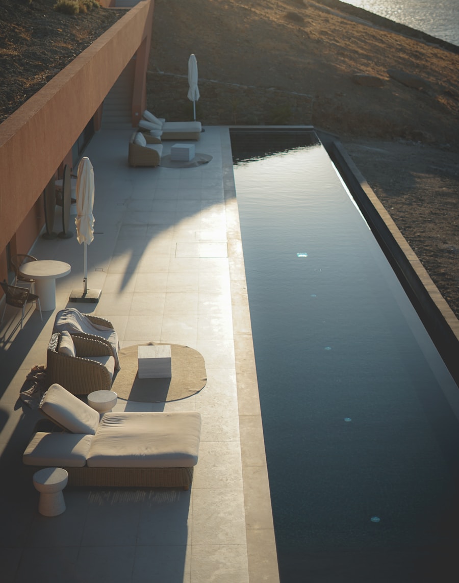 Narrow lap pool along the terrace of a contemporary concrete villa.